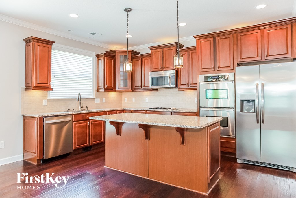 A kitchen with wooden cabinets and a refrigerator.