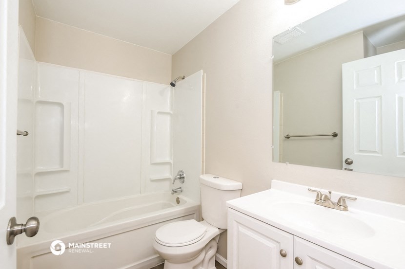a bathroom with a sink toilet and a tub