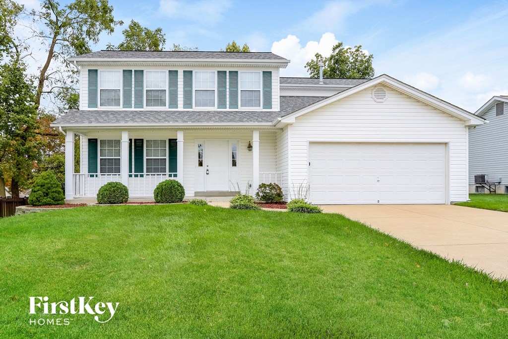 a white house with a lawn in front of it