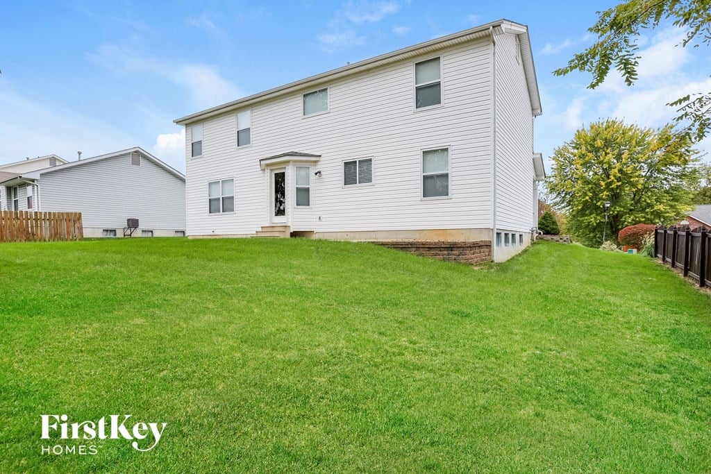 a white house with a yard in front of it