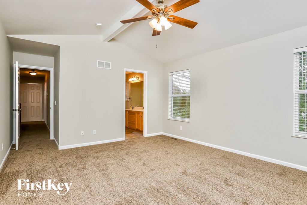 the master bedroom is spacious and has a ceiling fan