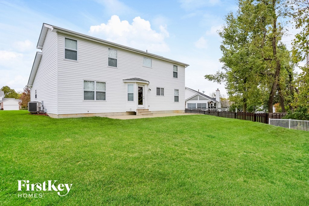 a white house with a yard in front of it