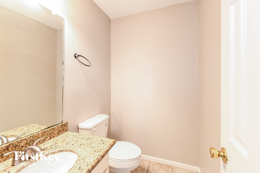 a bathroom with a toilet and a sink and a mirror