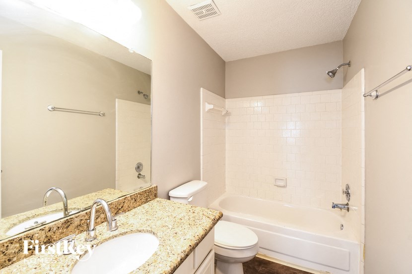 a bathroom with a sink and a tub and a toilet