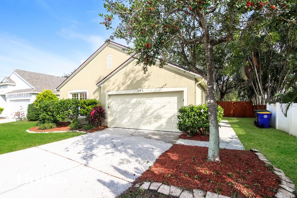 a garage door in front of a house with a tree