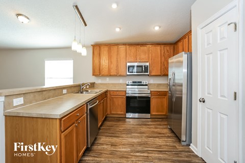 A kitchen with wooden cabinets and stainless steel appliances.