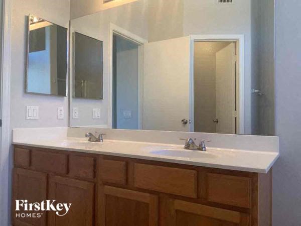 A bathroom vanity with a mirror above it.