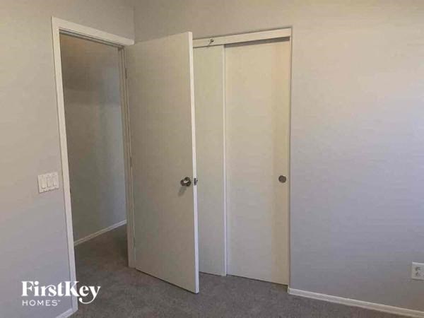 A room with two doors and a wall socket.