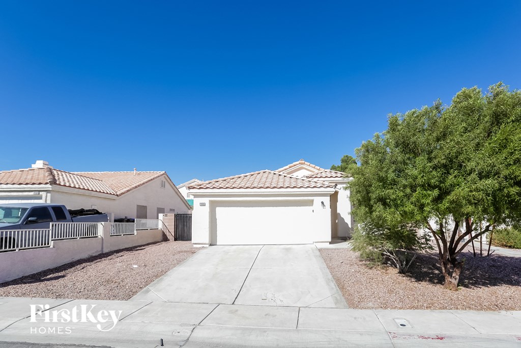 a home with a white garage door and a driveway