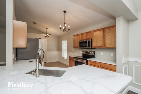 a kitchen with white counter tops and a sink