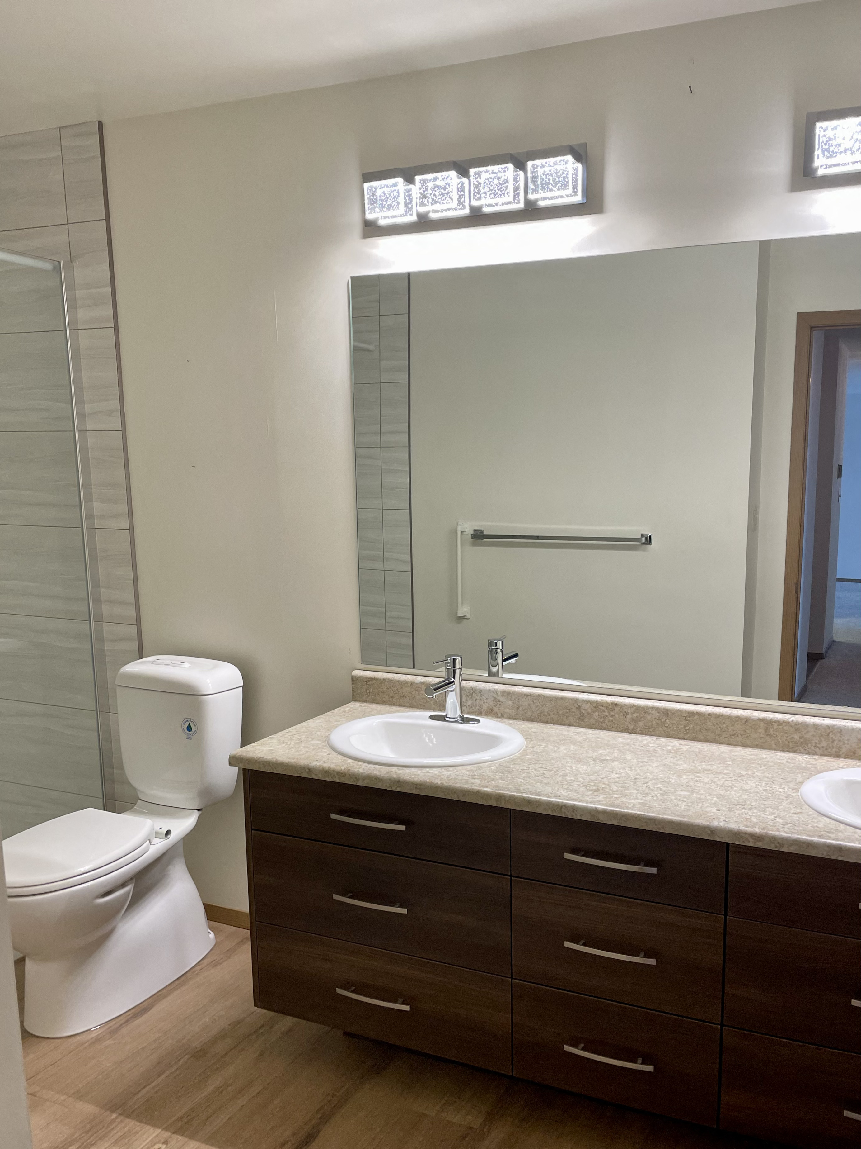 a bathroom with a mirror and a sink and a toilet