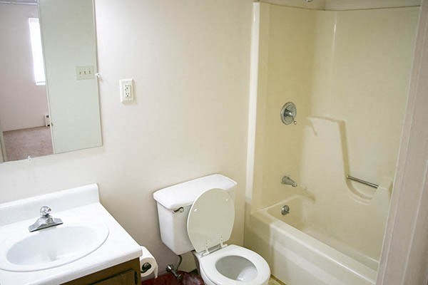 a bathroom with a toilet and a sink and a bath tub