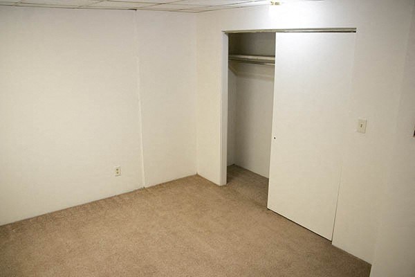 an empty room with a closet and an open door
