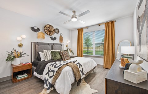 a bedroom with a bed and a ceiling fan