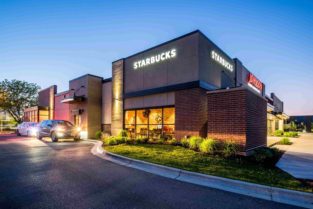 A Starbucks sign is on the side of a building.