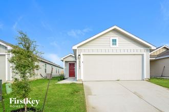 a white house with a driveway and a garage door