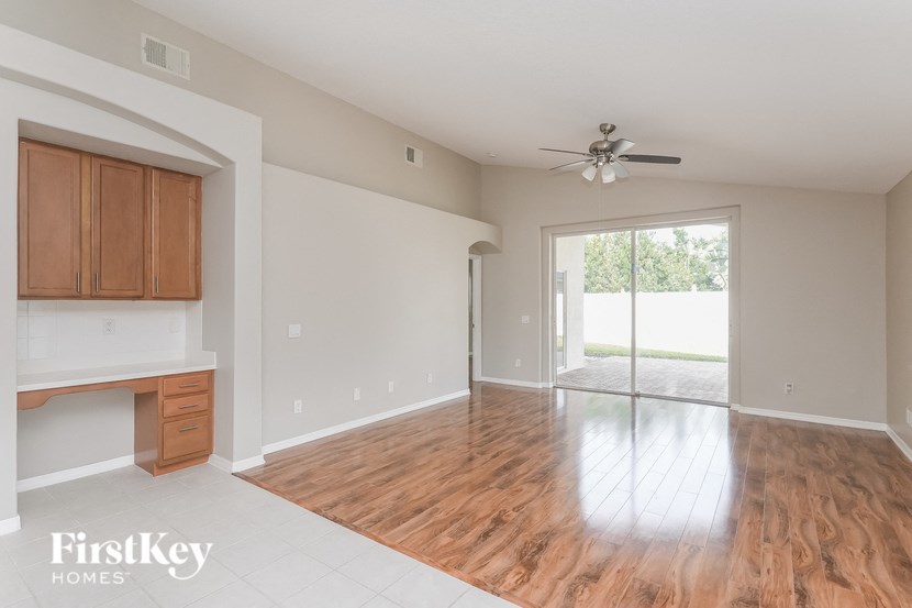 A room with wooden floors and a ceiling fan.