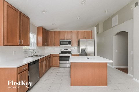 A kitchen with wooden cabinets and a white countertop.