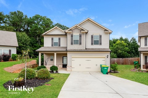 a beige house with a white garage door
