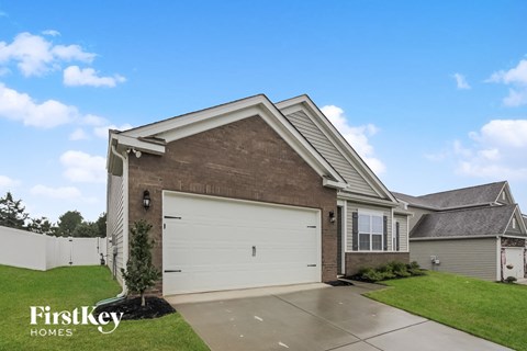 a house with a white garage door and a lawn
