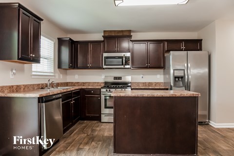 a kitchen with stainless steel appliances and marble counter tops