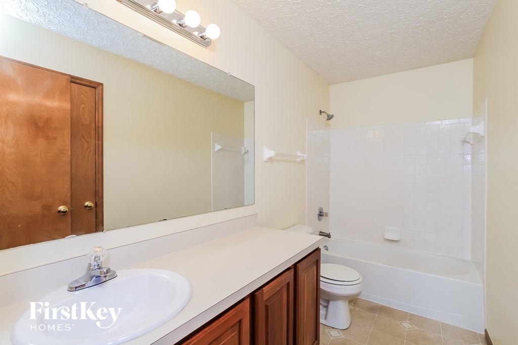 a bathroom with a sink and a toilet and a shower