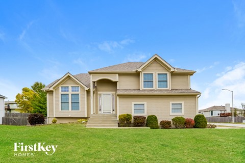 A house with a lawn in front of it.
