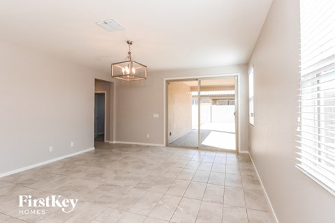 an empty hallway with a large window and a door into a house