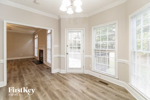 the living room and dining room of a house with wood flooring
