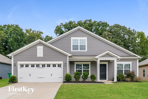 a gray house with a white garage door