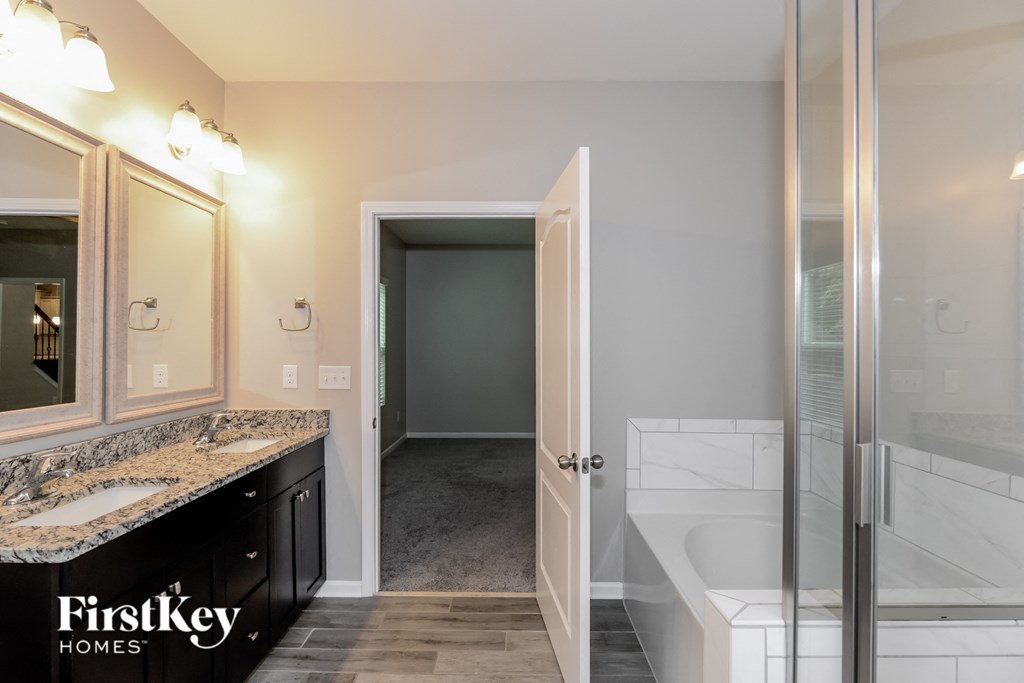 a bathroom with a shower and a sink and a mirror