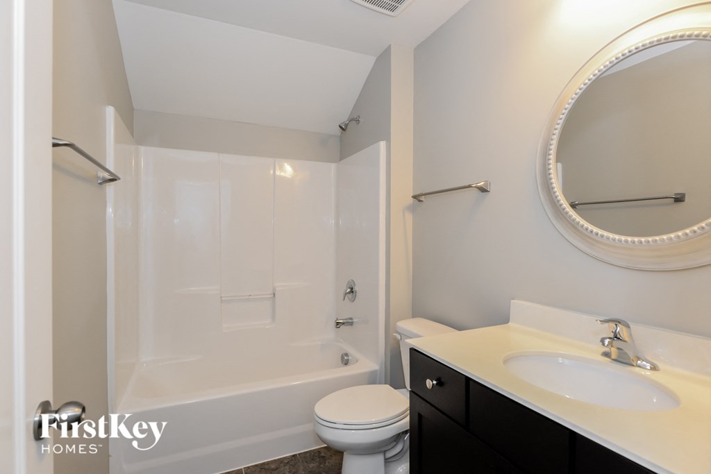 a bathroom with a sink toilet and a shower