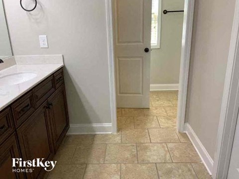 a bathroom with a sink and a white door