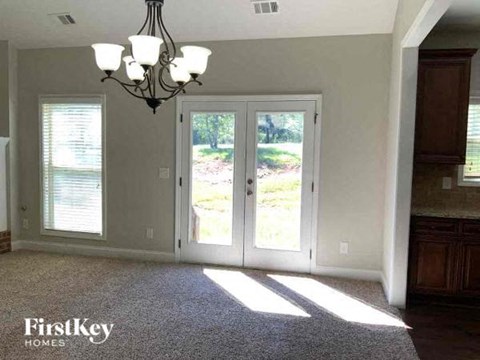 a living room with a door and a chandelier