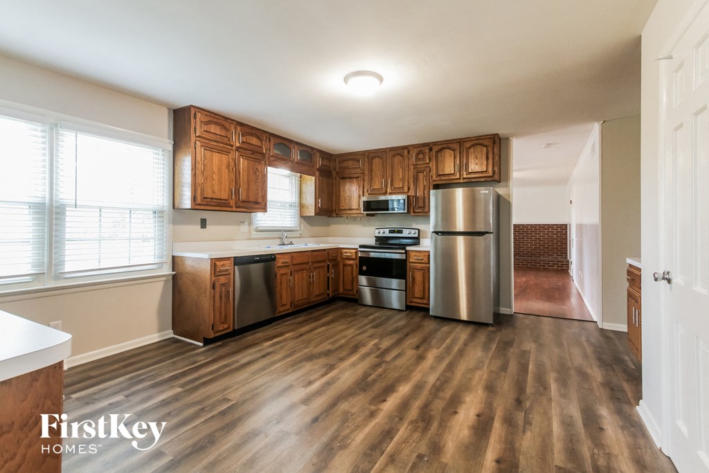 a kitchen with wooden cabinets and stainless steel appliances