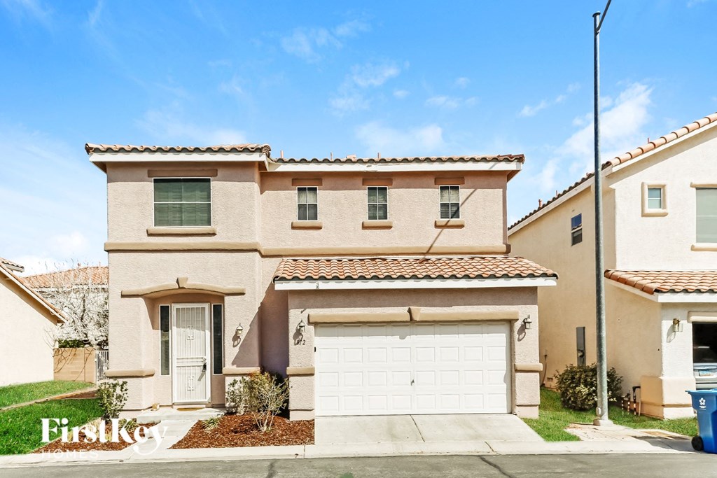 a beige house with a white garage door