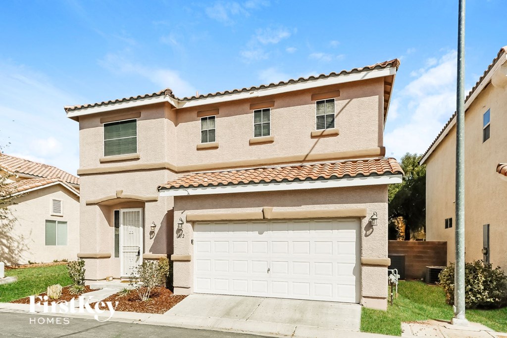 a house with a white garage door in front of it
