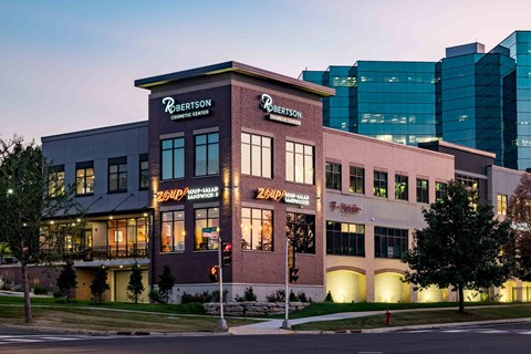 The exterior of the Robertson Clinic building is shown at dusk.