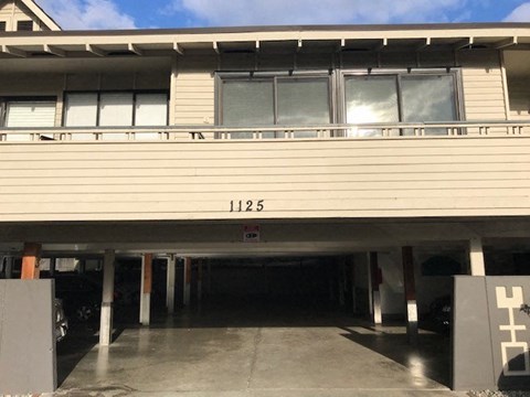 the front of a building with a parking garage