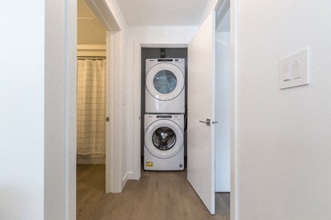 A washing machine is in a small laundry room.