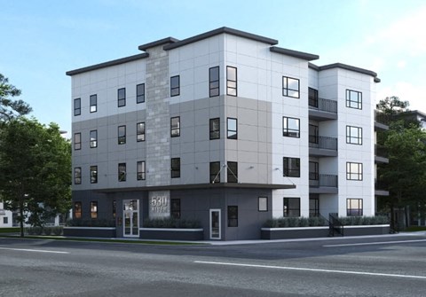 A modern apartment building with a grey and white facade.