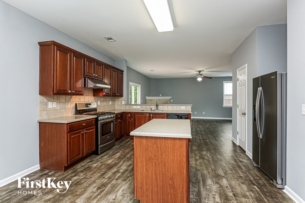 A kitchen with wooden cabinets and a white countertop.