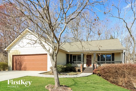 a white house with a tree in front of it