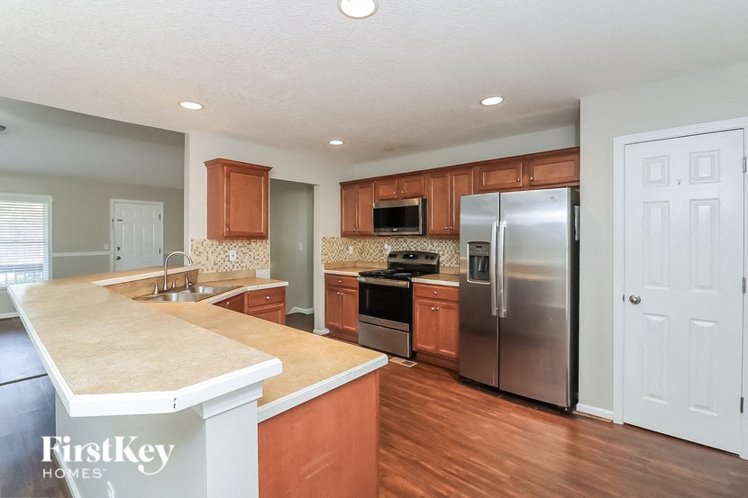 a kitchen with wooden cabinets and stainless steel appliances