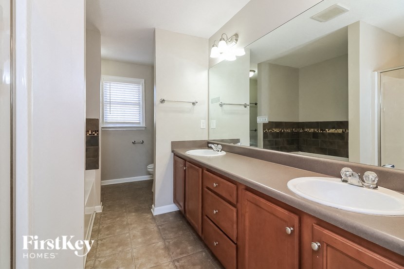 a bathroom with two sinks and a large mirror