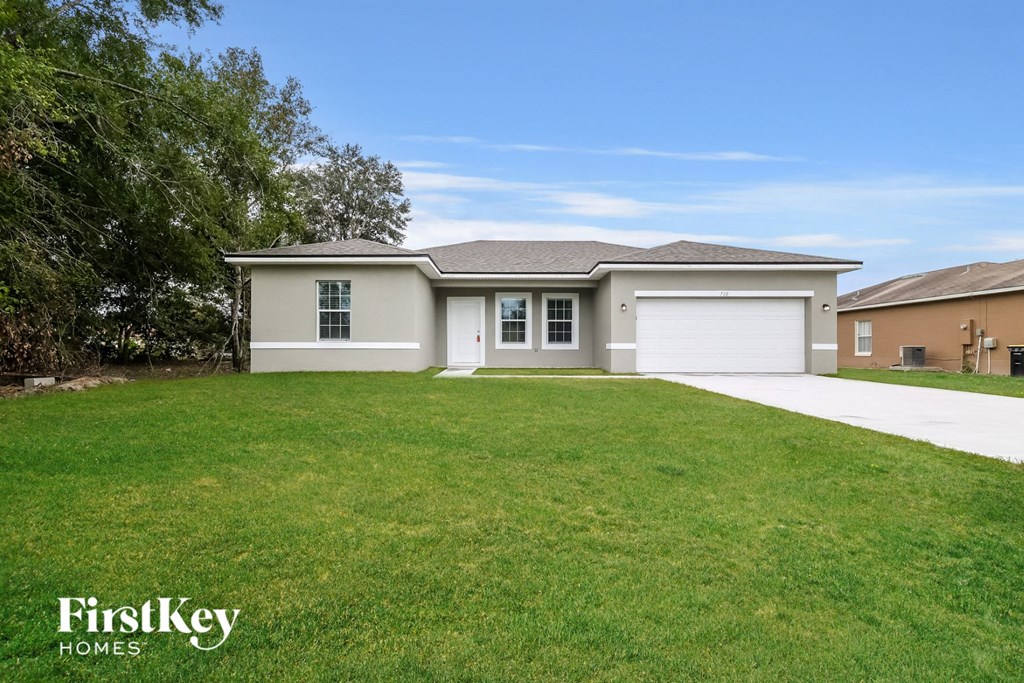A house with a white garage door is for sale.