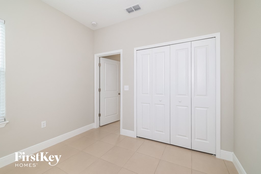 A room with a white door and a white wardrobe.