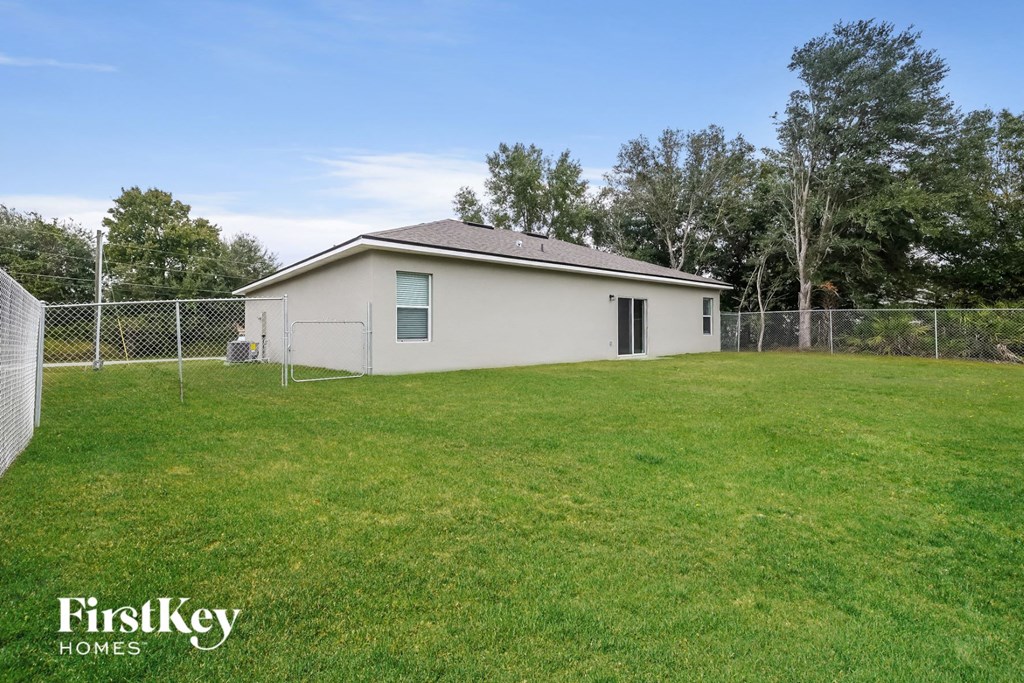 A small house with a fence in front of it.