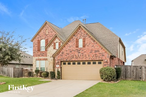 a brick house with a brown garage door