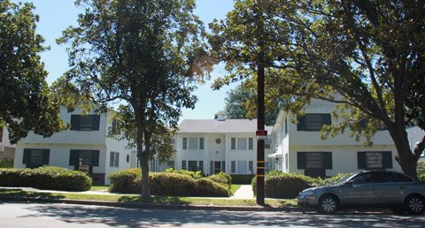 an apartment building with a car parked in front of it